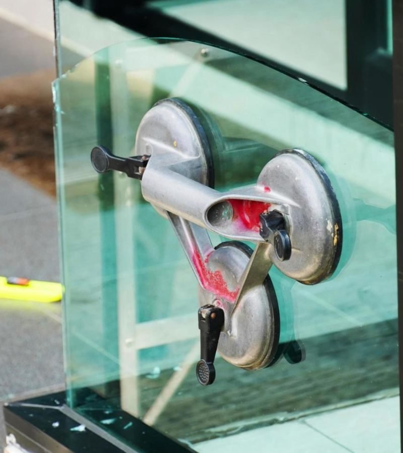 A glass door displaying a metal pole, symbolizing the window glass restoration service offered.
